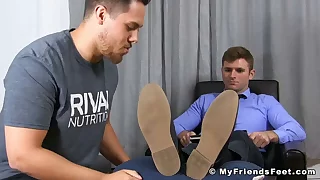 Handsome businessman foot worshipped by his lovable friend